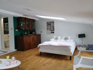 a bedroom with a bed and a room with a table at Z widokiem- Old Town in Kraków