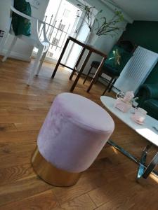 a white stool sitting on the floor in a living room at Z widokiem- Old Town in Kraków +27 photos