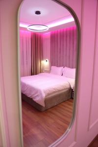a bedroom with a large bed with a mirror at Sky View Hotel & Restaurant in Kukës