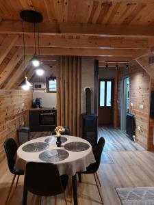 a dining room with a table and a kitchen at Snowflake in Žabljak