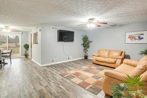 a living room with two couches and a flat screen tv at Spacious Delaware Home with Private Hot Tub! in Delaware