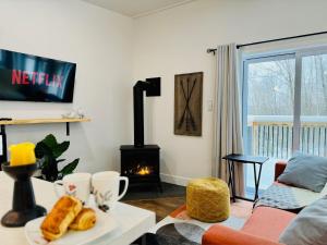 ein Wohnzimmer mit einem Kamin und einem Sofa in der Unterkunft Woodpecker Spa and peace in Orford