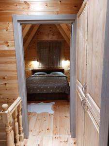 a bedroom in a log cabin with a bed in it at Snowflake in Žabljak