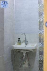 a white sink in a tiled bathroom at Asilah kato nubian guest house in Aswan