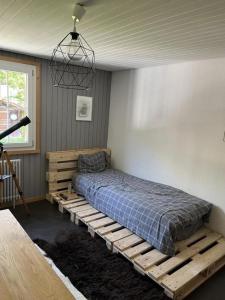 a bedroom with a wooden bed in a room at Gemütliche 45 Zimmerwohnung in den Bündner Bergen bei Sedrun in Rueras