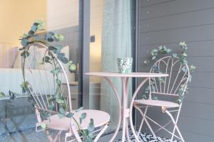 a table and two chairs and a table and chairs with plants at Apex Lofts Suite - Modern 2 bed with rooftop terrace in Birmingham