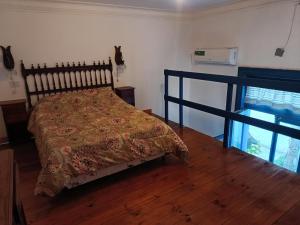 a bedroom with a bed with a blanket on it at Villa Azul in Buenos Aires