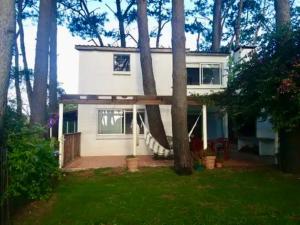 a house with a hammock in the front of it at Altamira 1 in Punta del Este