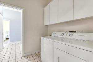 a white laundry room with a washer and dryer at Oceanfront Villa 2(103) - Boardwalk oceanfront in Ocean City +58 photos