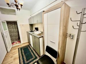 a small kitchen with a table and a chair in a room at Ming with free parking in Braşov