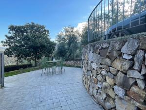 un muro di pietra con tavolo e recinto di Casa Calma a Quarrata