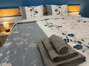 a bed with two towels on top of it at Стаи за гости малчика in Plovdiv +13 photos