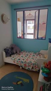 a childs bedroom with a bed and a window at Appartement avec terrasse in Saint-Denis