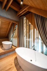 a bathroom with a white tub and a large window at Aparthouse Lubno in Frýdlant nad Ostravicí