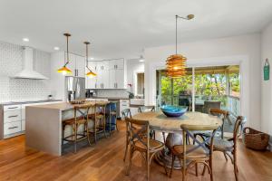 a kitchen and dining room with a table and chairs at Poipu Kai 5 Bed 3 Bath Home- Alekona Kauai in Koloa