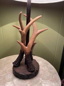 a statue of a tree with antlers on a table at Restful Retreat in Grantsburg