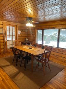 a dining room with a wooden table and chairs at Restful Retreat in Grantsburg