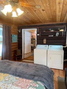 a bedroom with a bed and a washer and dryer at Restful Retreat in Grantsburg