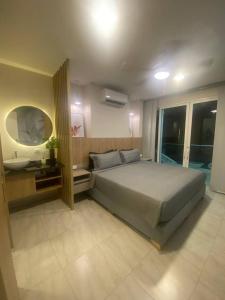 a bedroom with a large bed and a sink at Miami Hotel Cartagena - Luxury Apartments in Cartagena de Indias