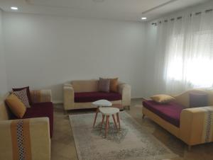 a living room with couches and a table at Jad tunis in Tunis