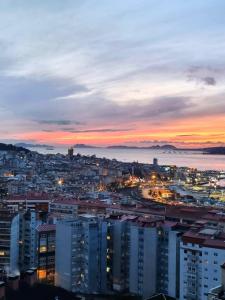 a city skyline at night with a sunset at VistasAragon in Vigo