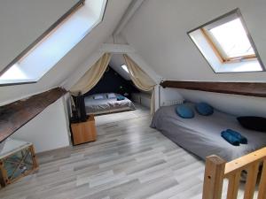 a attic bedroom with two beds and skylights at A la découverte du cotentin in Cherbourg en Cotentin
