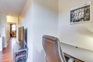 a living room with a chair and a television at Cozy Easton Condo Near Historic Downtown in Easton