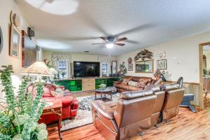 a living room with leather furniture and a ceiling fan at Spacious Brandon Home 10 Mi to Downtown Tampa! in Brandon