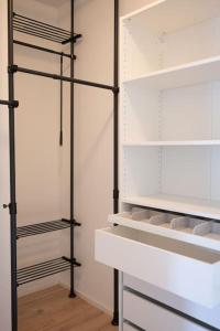 a walk in closet with black and white shelves at Kaunis moderni tilava asunto in Rauma
