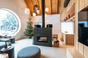 a living room with a fireplace in a house at Aparthouse Lubno in Frýdlant nad Ostravicí