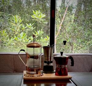 a blender and a coffee maker on a table at Glamping Rio Sur in Puerto Varas