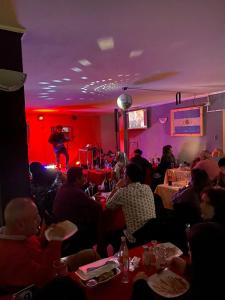 a group of people sitting in a room with a man on a stage at Hotel Gran Riviera in Cartagena