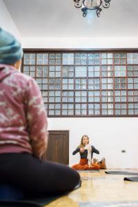 a woman sitting on the floor in front of a mirror at Vihara - Spa, Yoga, Wellness & Events in Antigua Guatemala