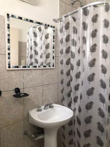 a bathroom with a sink and a shower curtain at Lo de tungo in Paraná