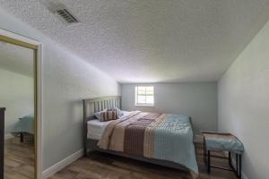 a bedroom with a bed and a window at Lake Side Loft Appt in Loxahatchee