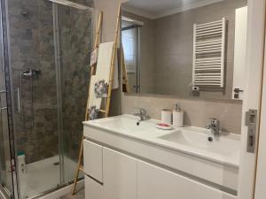 a bathroom with a sink and a shower at Casa da Burra in Alijó