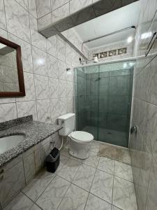 a bathroom with a shower and a toilet and a sink at Lize Prime Hotel in Campinas