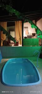 a blue bath tub in a room with a room with at Canto da Natureza in Governador Celso Ramos