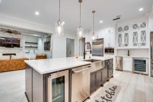 a kitchen with white cabinets and stainless steel appliances at Sprawling Suwanee Home Theater, Pool, Hot Tub! in Suwanee