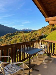 a table and two chairs on a balcony with a view at Casa Campanula - No 1 Ferienhaus in Laax in Laax