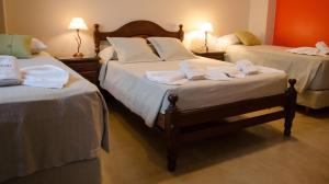 a bedroom with two beds with towels on them at Munay Salta in Salta