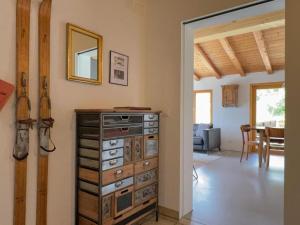 a room with a chest of drawers and a dining room at Casa Campanula - No 1 Ferienhaus in Laax in Laax