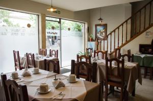 a restaurant with tables and chairs in a room at Munay Salta in Salta