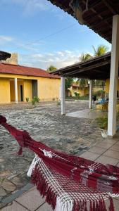 a red and white rug in front of a building at Chácara in Estância