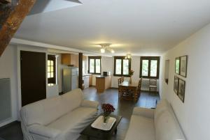 a living room with a couch and a table at Ferme Sainte Marie in Rémilly