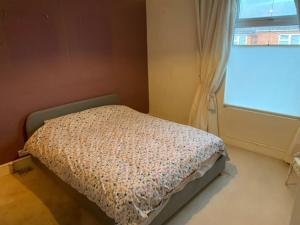 a small bed in a room with a window at Holiday Home in Kidderminster in Kidderminster