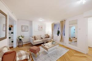 a living room with a couch and a table at Park Lane Apartments Harrowby street in London