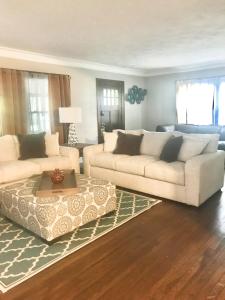 a living room with two couches and a coffee table at Euclid Beach within reach in Euclid