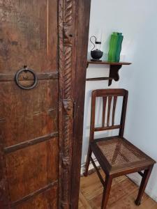 a wooden door with a chair next to a shelf at Dom Pracy Twórczej Muchomorek in Pieszyce