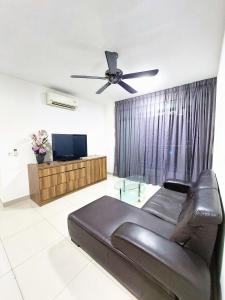 a living room with a couch and a ceiling fan at TuR15 PisaStadium 4rooms PrivateHouse in Bayan Lepas